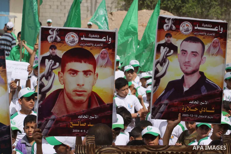 Palestinian children take part in a summer camp organized by Hamas on June 3, 2014. Thousands of elementary school students in the Gaza Strip are going to Hamas summer camps, in which they take part in recreational activ...