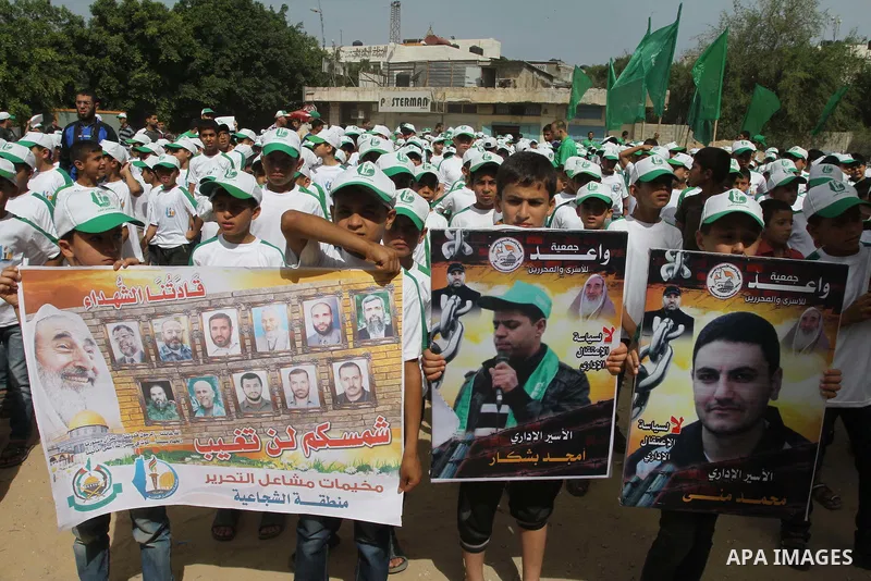 Palestinian children take part in a summer camp organized by Hamas on June 3, 2014. Thousands of elementary school students in the Gaza Strip are going to Hamas summer camps, in which they take part in recreational activ...