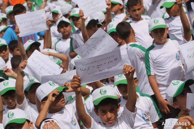 Palestinian children take part in a summer camp organized by Hamas on June 3, 2014. Thousands of elementary school students in the Gaza Strip are going to Hamas summer camps, in which they take part in recreational activ...