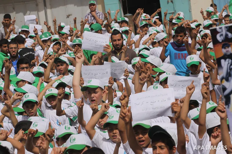Palestinian children take part in a summer camp organized by Hamas on June 3, 2014. Thousands of elementary school students in the Gaza Strip are going to Hamas summer camps, in which they take part in recreational activ...