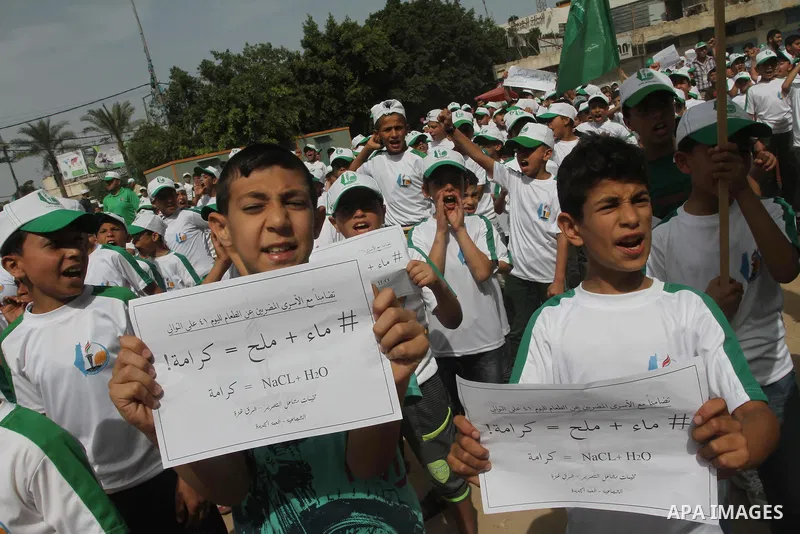 Palestinian children take part in a summer camp organized by Hamas on June 3, 2014. Thousands of elementary school students in the Gaza Strip are going to Hamas summer camps, in which they take part in recreational activ...