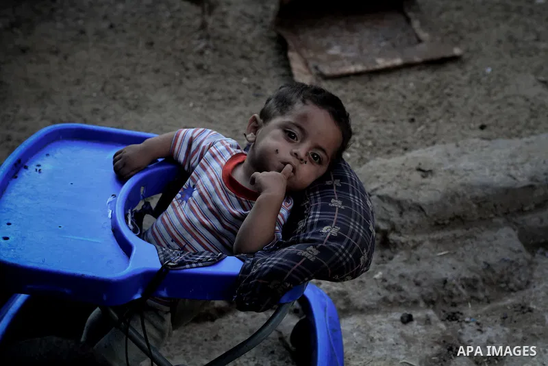 A Palestinian child plays outside his house at Al-Zaitoun neighborhood in the central Gaza Strip, on June 02, 2014. Photo by Ezz al-Zanoun