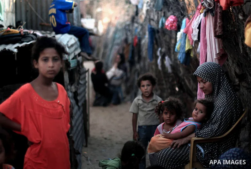 Palestinian children play outside their house at Al-Zaitoun neighborhood in the central Gaza Strip, on June 02, 2014. Photo by Ezz al-Zanoun