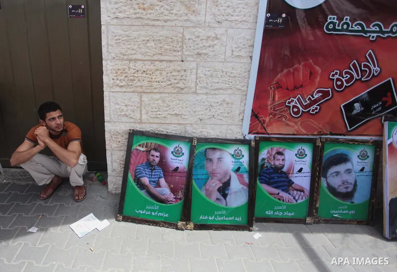 A Palestinian man takes part during a protest to solidarity with Palestinian prisoners held in Israeli jails, in front of Red cross office Gaza city, on June 03, 2014. It was about 120 Palestinians imprisoned without tri...
