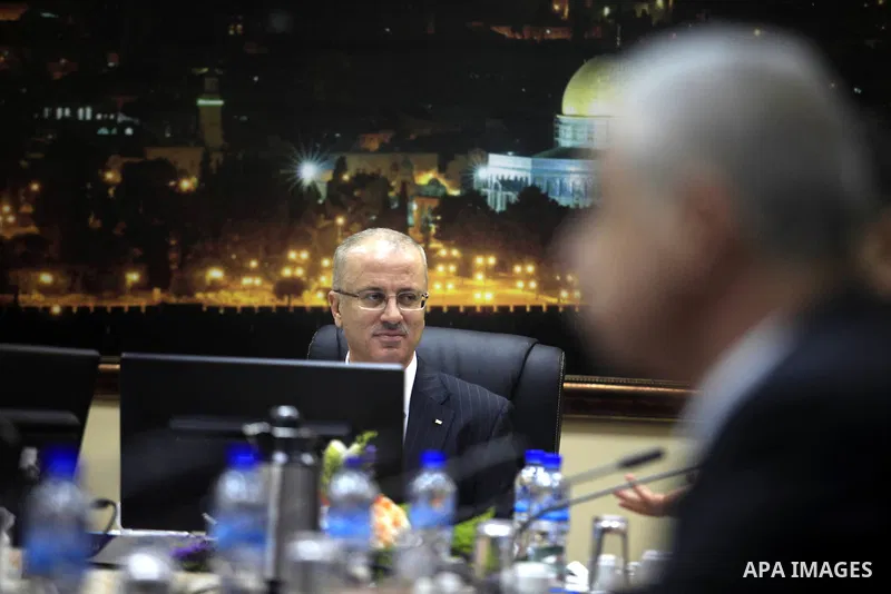 Prime Minister Rami Al-Hamdallah attends his first meeting of the new unity government cabinet, in the West Bank city of Ramallah, on June 3, 2014. The Palestinian national unity government was sworn in on Monday before...