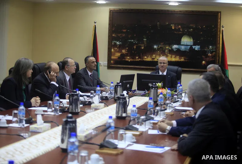 Prime Minister Rami Al-Hamdallah attends his first meeting of the new unity government cabinet, in the West Bank city of Ramallah, on June 3, 2014. The Palestinian national unity government was sworn in on Monday before...