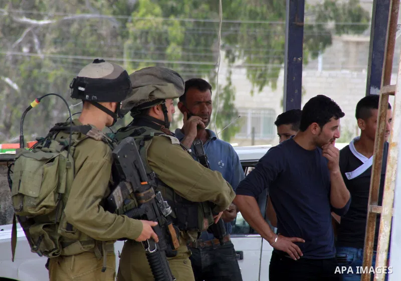 Israeli soldiers stop Palestinians during a search operation in the west Bank village of Howwara near Nablus, 03 June 2014. Palestinian Alaa Mohammed Awad Odeh was shot and killed the previous night bt Israeli Defense Fo...