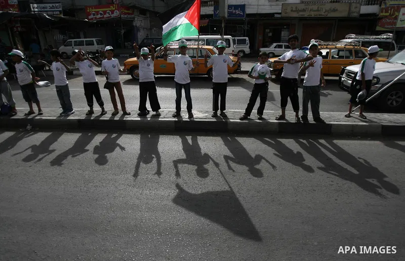 Palestinian children who participate in a summer camp organized by Hamas, parade the streets during a rally to show solidarity with Palestinian prisoners held in Israeli jails, in Rafah in the southern Gaza Strip, on Jun...