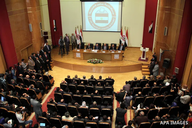 Egyptian judge Anwar Rashad al-Asi (C), head of the presidential election commission, holds a press conference in the capital Cairo on June 3, 2014, in which he announces that Ex-army chief Abdel Fattah al-Sisi won 96.9...