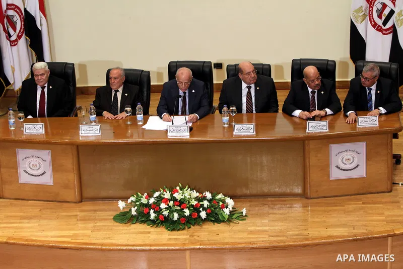 Egyptian judge Anwar Rashad al-Asi (C), head of the presidential election commission, holds a press conference in the capital Cairo on June 3, 2014, in which he announces that Ex-army chief Abdel Fattah al-Sisi won 96.9...