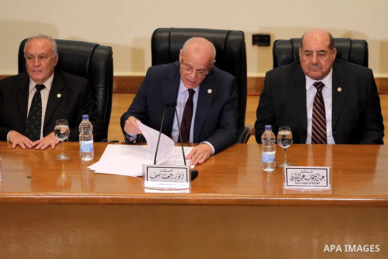 Egyptian judge Anwar Rashad al-Asi (C), head of the presidential election commission, holds a press conference in the capital Cairo on June 3, 2014, in which he announces that Ex-army chief Abdel Fattah al-Sisi won 96.9...