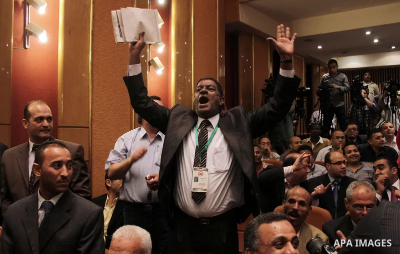 Egyptian journalists and State Information Service (SIS) employees celebrate at the end of a press conference in the capital Cairo on June 3, 2014, in which the electoral commission announced that Ex-army chief Abdel Fat...