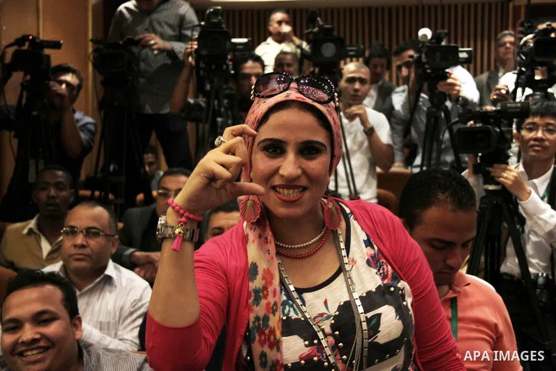 Egyptian journalists and State Information Service (SIS) employees celebrate at the end of a press conference in the capital Cairo on June 3, 2014, in which the electoral commission announced that Ex-army chief Abdel Fat...