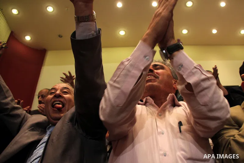 Egyptian journalists and State Information Service (SIS) employees celebrate at the end of a press conference in the capital Cairo on June 3, 2014, in which the electoral commission announced that Ex-army chief Abdel Fat...