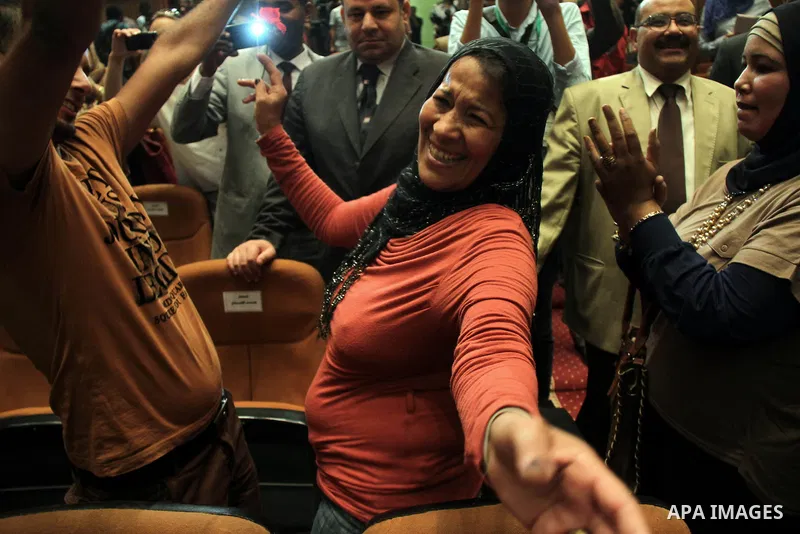 Egyptian journalists and State Information Service (SIS) employees celebrate at the end of a press conference in the capital Cairo on June 3, 2014, in which the electoral commission announced that Ex-army chief Abdel Fat...
