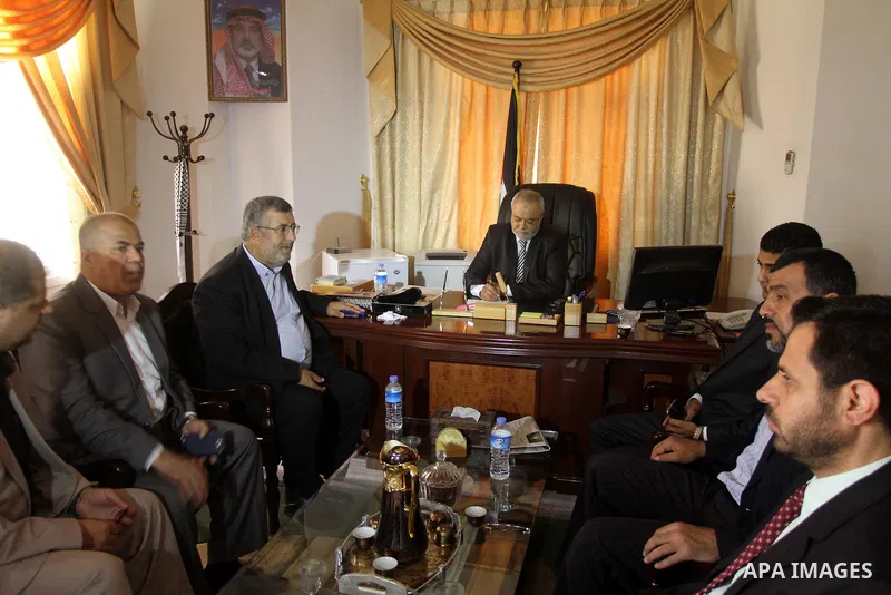 Palestinian Minister of Justice Salim Al Sakkaa attends his first meeting of the new unity government, in Gaza city, on June 04, 2014. The Palestinian national unity government was sworn in on Monday before Palestinian P...