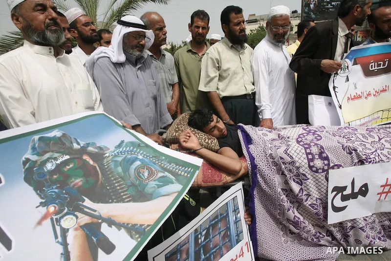 Palestinians take part a protest to solidarity with Palestinian prisoners held in Israeli jails, in Rafah in the southern Gaza strip June 04, 2014. About 120 Palestinians imprisoned without trial in Israel on an open hun...
