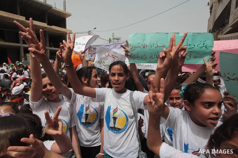 Palestinian children take part in a summer camp organized by Hamas on June 4, 2014. Thousands of elementary school students in the Gaza Strip are going to Hamas summer camps, in which they take part in recreational activ...