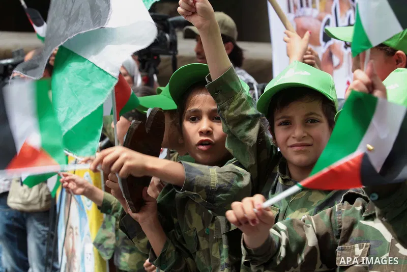 Palestinian children take part in a summer camp organized by Hamas on June 4, 2014. Thousands of elementary school students in the Gaza Strip are going to Hamas summer camps, in which they take part in recreational activ...