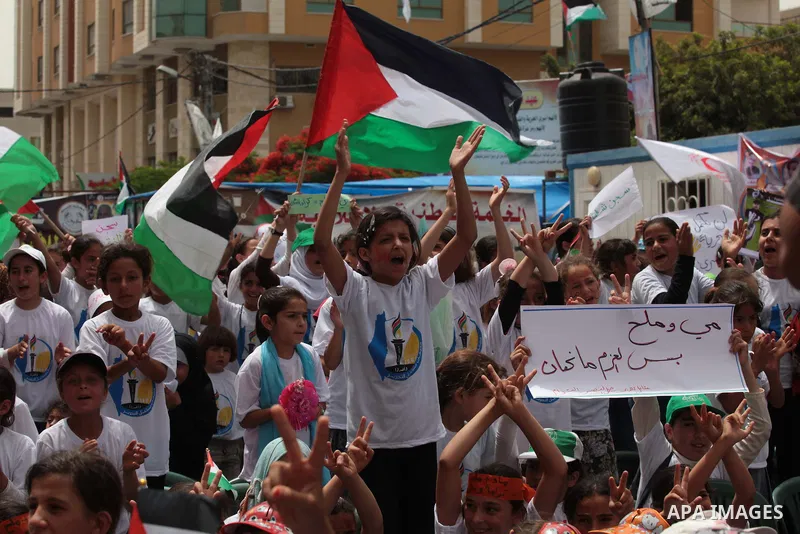 Palestinian children take part in a summer camp organized by Hamas on June 4, 2014. Thousands of elementary school students in the Gaza Strip are going to Hamas summer camps, in which they take part in recreational activ...