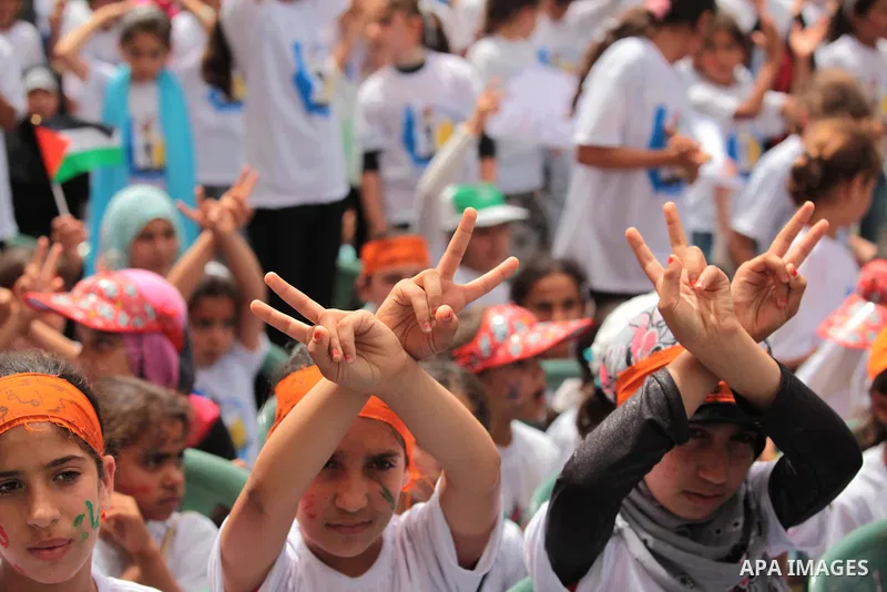 Palestinian children take part in a summer camp organized by Hamas on June 4, 2014. Thousands of elementary school students in the Gaza Strip are going to Hamas summer camps, in which they take part in recreational activ...