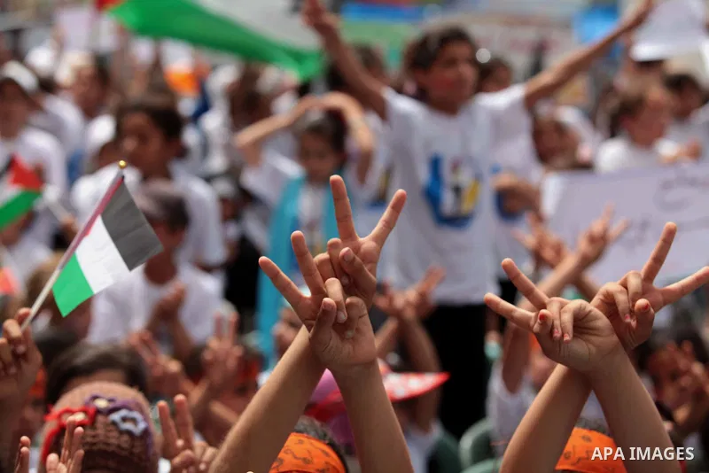 Palestinian children take part in a summer camp organized by Hamas on June 4, 2014. Thousands of elementary school students in the Gaza Strip are going to Hamas summer camps, in which they take part in recreational activ...