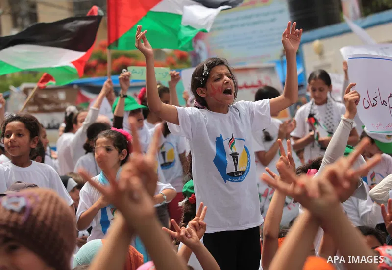 Palestinian children take part in a summer camp organized by Hamas on June 4, 2014. Thousands of elementary school students in the Gaza Strip are going to Hamas summer camps, in which they take part in recreational activ...