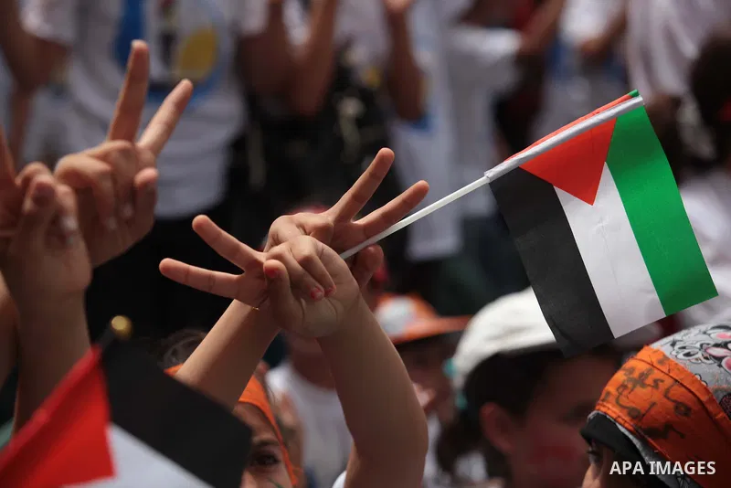 Palestinian children take part in a summer camp organized by Hamas on June 4, 2014. Thousands of elementary school students in the Gaza Strip are going to Hamas summer camps, in which they take part in recreational activ...