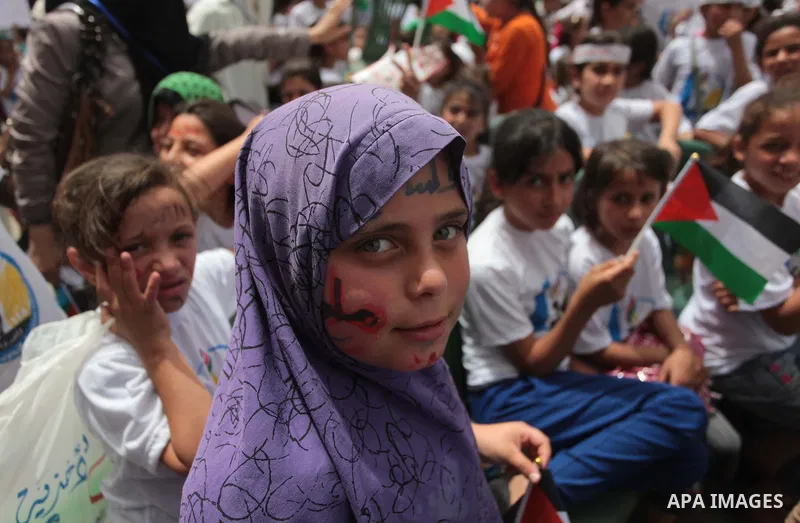 Palestinian children take part in a summer camp organized by Hamas on June 4, 2014. Thousands of elementary school students in the Gaza Strip are going to Hamas summer camps, in which they take part in recreational activ...