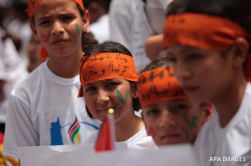 Palestinian children take part in a summer camp organized by Hamas on June 4, 2014. Thousands of elementary school students in the Gaza Strip are going to Hamas summer camps, in which they take part in recreational activ...