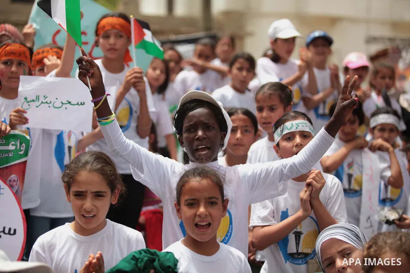 Palestinian children take part in a summer camp organized by Hamas on June 4, 2014. Thousands of elementary school students in the Gaza Strip are going to Hamas summer camps, in which they take part in recreational activ...