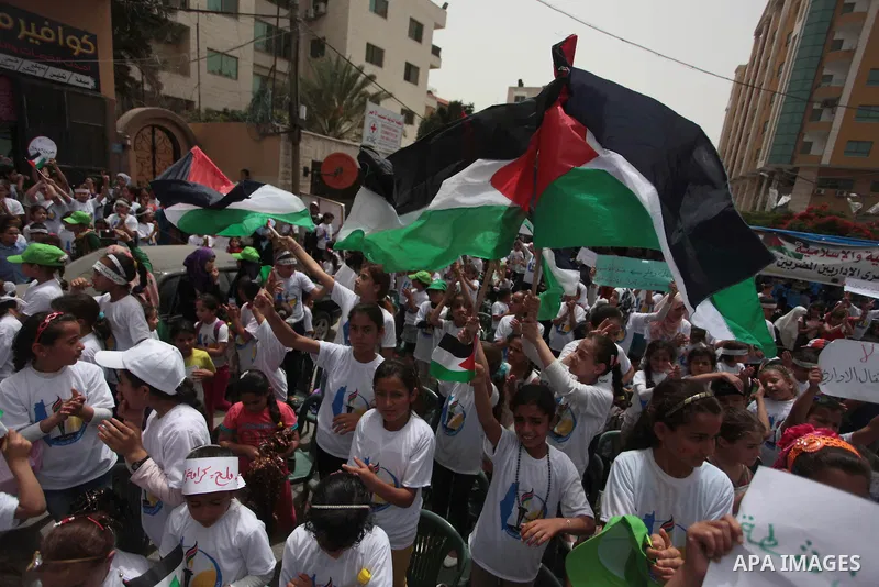 Palestinian children take part in a summer camp organized by Hamas on June 4, 2014. Thousands of elementary school students in the Gaza Strip are going to Hamas summer camps, in which they take part in recreational activ...