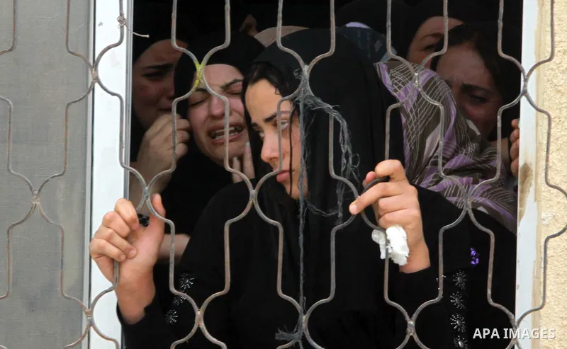 Palestinian wife Eman Odeh mourns the body of Alaa Odeh during his funeral in Huwara village near Nablus, the northern West Bank, Wednesday, June 4, 2014. The Israeli military says troops shot and killed Odeh at a checkp...
