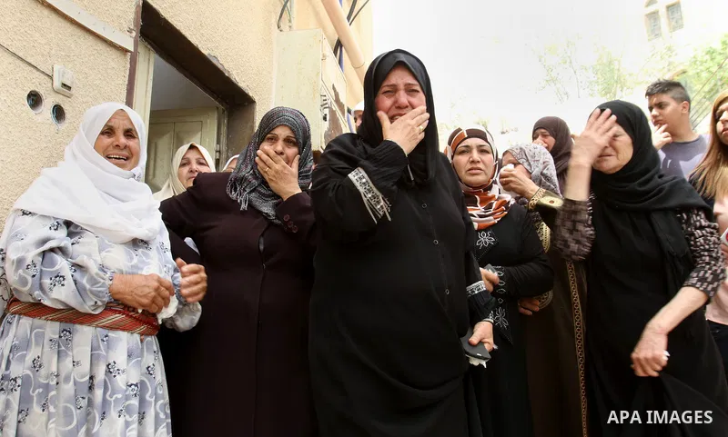 Palestinian relatives of Alaa Odeh mourn during his funeral in Huwara village near Nablus, the northern West Bank, Wednesday, June 4, 2014. The Israeli military says troops shot and killed Odeh at a checkpoint after he o...