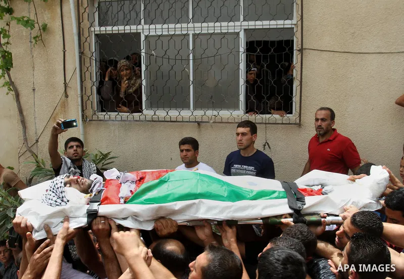 Palestinians carry the body of Alaa Odeh during his funeral in Huwara village near Nablus, the northern West Bank, Wednesday, June 4, 2014. The Israeli military says troops shot and killed Odeh at a checkpoint after he o...