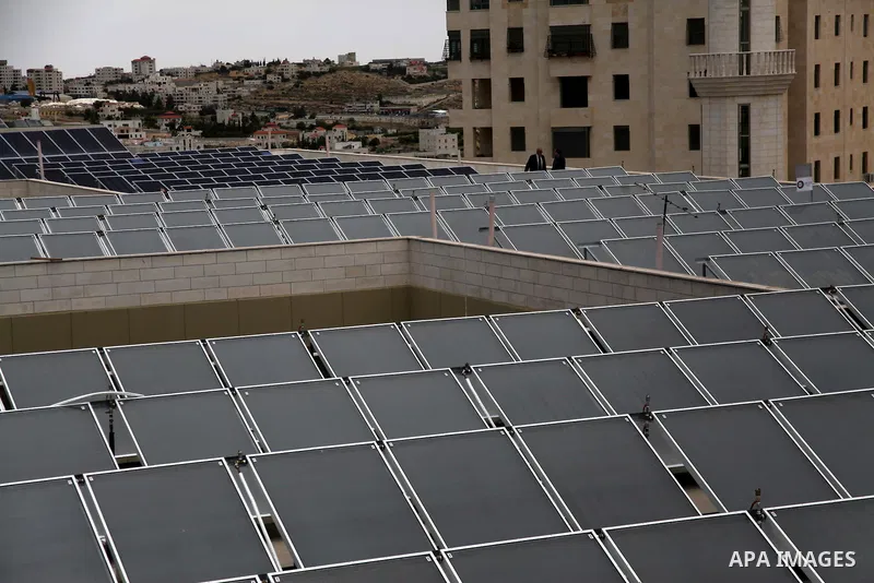 Palestinian engineer Mohammed Tamimi inspects solar panels, at al-Ahli hospital in the West Bank City of Hebron, June May 04, 2014. Al-Ahli Hospital Wind Energy Project (AWEP) funded by European Union, is an innovative p...