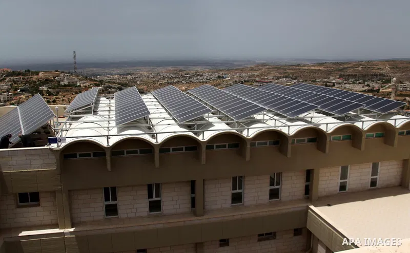 Palestinian engineer Mohammed Tamimi inspects solar panels, at al-Ahli hospital in the West Bank City of Hebron, June May 04, 2014. Al-Ahli Hospital Wind Energy Project (AWEP) funded by European Union, is an innovative p...