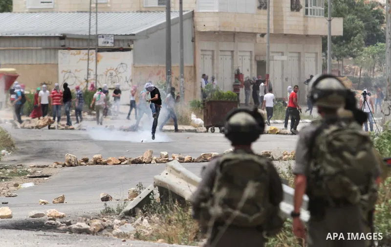 Palestinian protesters throw stones at Israeli security forces during clashes after a protest in support of Palestinian prisoners hunger striking since 42 days in Israeli jails, outside Ofer, an Israeli military prison n...
