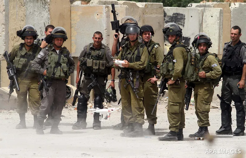 Israeli soldiers use a remote-controlled 'helicopter' with camera to capture the Palestinian protesters during clashes after a protest in support of Palestinian prisoners hunger striking since 42 days in Israeli jails, o...