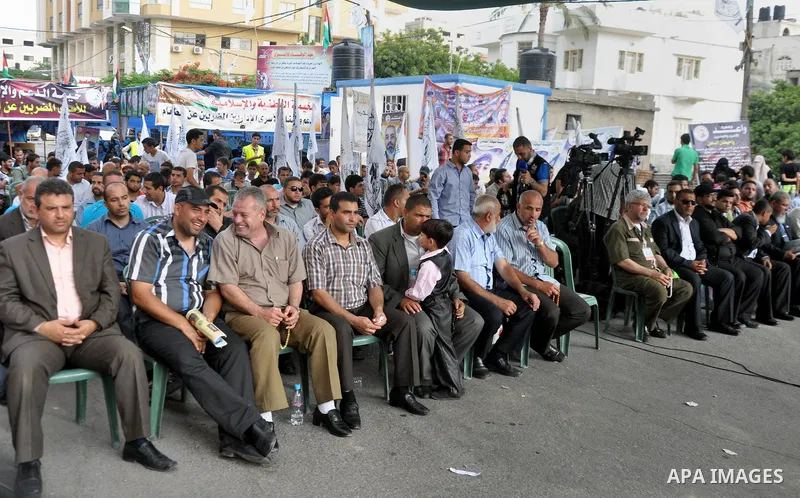 Palestinian supporters of al-Ahrar party take part a protest in the support of the prisoners who are on hunger strike, outside Red Cross Office, in Gaza city June 04, 2014. About 120 Palestinians imprisoned without trial...