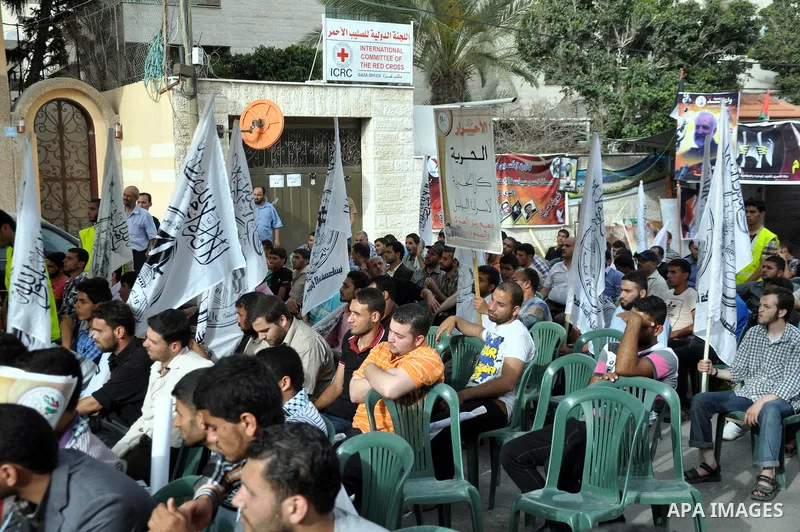 Palestinian supporters of al-Ahrar party take part a protest in the support of the prisoners who are on hunger strike, outside Red Cross Office, in Gaza city June 04, 2014. About 120 Palestinians imprisoned without trial...