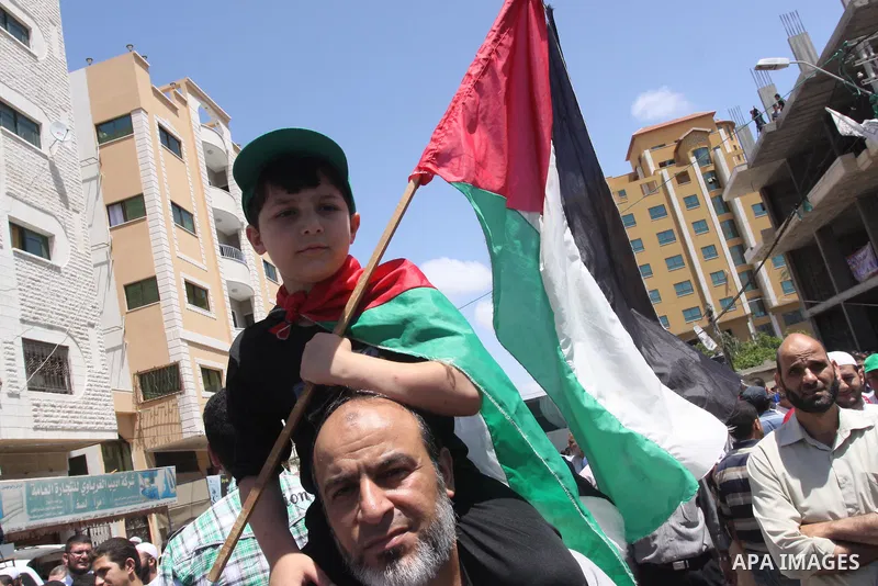 Palestinians take part in a rally in solidarity with prisoners on hunger strike, and the global alliance for the support of Al-Quds (Jerusalem) outside Red Cross office in Gaza City on June 6, 2014. Some 120 Palestinians...