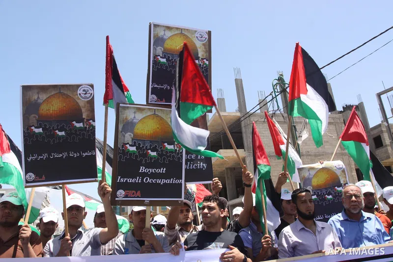 Palestinians take part in a rally in solidarity with prisoners on hunger strike, and the global alliance for the support of Al-Quds (Jerusalem) outside Red Cross office in Gaza City on June 6, 2014. Some 120 Palestinians...