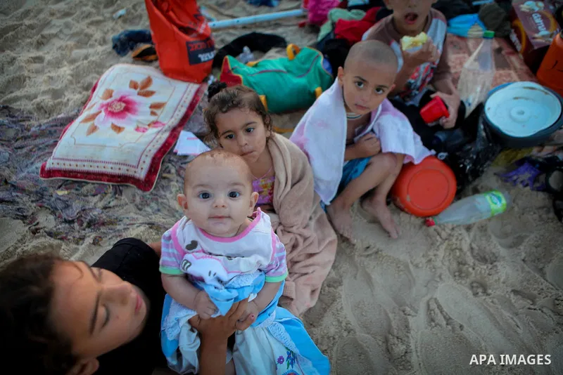 Palestinians children enjoy a summer day at the beach in Gaza city, on June 6, 2014. Friday is the Muslim holiday and as summer is entering many Palestinian people go to the beach since it is the major entertainment area...