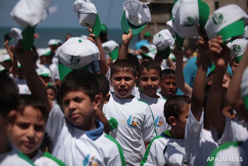 Palestinian children take part in a summer camp organized by Hamas on June 7, 2014. Thousands of elementary school students in the Gaza Strip are going to Hamas summer camps, in which they take part in recreational activ...
