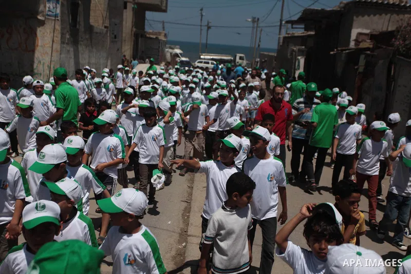 Palestinian children take part in a summer camp organized by Hamas on June 7, 2014. Thousands of elementary school students in the Gaza Strip are going to Hamas summer camps, in which they take part in recreational activ...