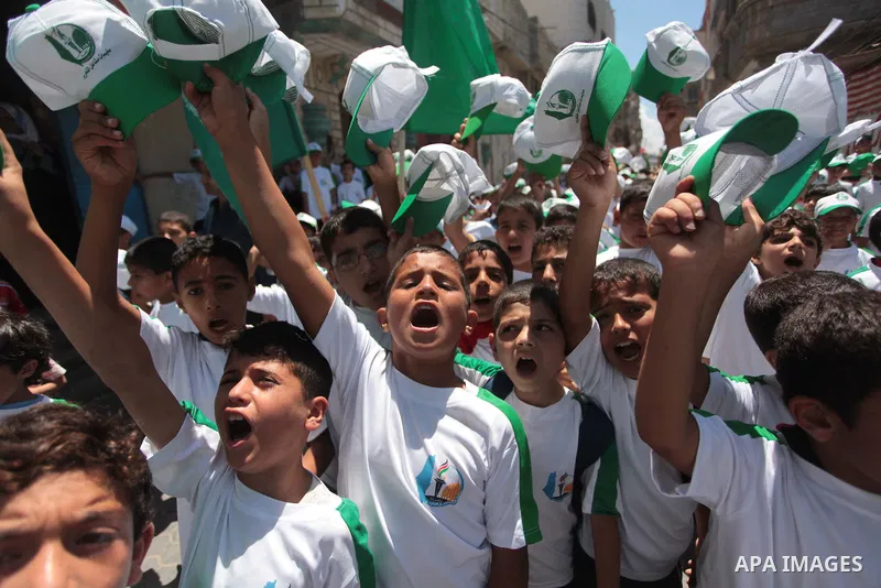 Palestinian children take part in a summer camp organized by Hamas on June 7, 2014. Thousands of elementary school students in the Gaza Strip are going to Hamas summer camps, in which they take part in recreational activ...
