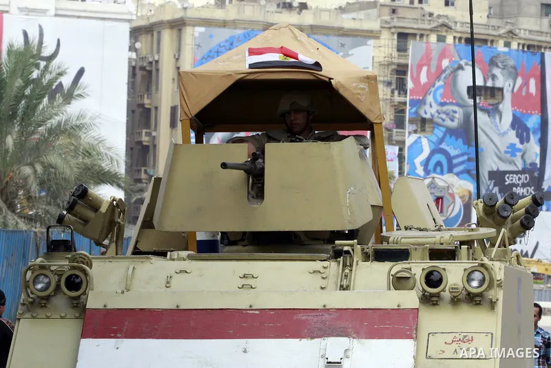 A Egyptian security officer stand guard on his military vehicle as Egyptians celebrate upon the completion of the swearing-in ceremony by President elect Abdel Fattah al-Sissi, in Tahrir square, Cairo, Egypt, 08 June 201...