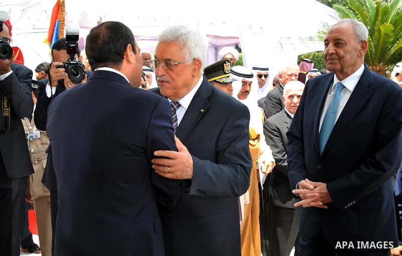 A handout picture made available on June 8, 2014 by the Egyptian presidency shows Egyptian President Abdel-Fattah el-Sissi, left, greets Palestinian President Mahmoud Abbas during his inauguration ceremonies at the presi...