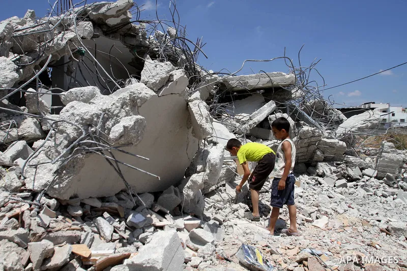 Palestinian children inspect their house destroyed by the Israeli army bulldozers in Pharaoh village near the West Bank city of Tulkarem, on June 9, 2014. The Israeli army bulldozers demolished the house of a Palestinian...